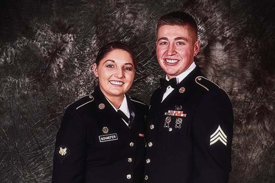 Bleau Hoge and his wife, Phoenix, pose for a picture while wearing their formal military attire